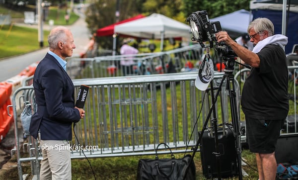 Michael Wuellenweber (left) and camera operator William Griffitts film their final footage outside the Fulton County Jail on Friday, Aug. 25, 2023, after the surrender of former President Donald Trump. (John Spink / John.Spink@ajc.com)