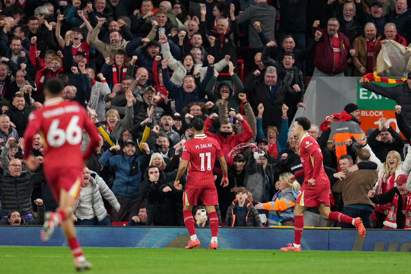 Liverpool's Mohamed Salah, centre, celebrates after scoring his side's second goal during the English Premier League soccer match between Liverpool and Brighton at the Anfield stadium in Liverpool, England, Saturday, Nov. 2, 2024. (AP Photo/Jon Super)