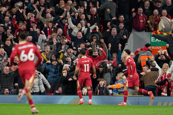 Liverpool's Mohamed Salah, centre, celebrates after scoring his side's second goal during the English Premier League soccer match between Liverpool and Brighton at the Anfield stadium in Liverpool, England, Saturday, Nov. 2, 2024. (AP Photo/Jon Super)