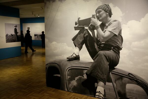 In this photo taken Thursday, May 11, 2017, is a 1935 image of Dorothea Lange atop a car in Texas on the plains that is in the exhibit "Dorothea Lange: Politics of Seeing," at the Oakland Museum of California in Oakland, Calif. The three major themes of the Lange display are the Great Depression, the home front during World War II and the urban decline and postwar sprawl in California. Running through August 13, the exhibit includes 100 of Lange's photographs, including recognized works as well as new, improved unframed prints that have been digitally scanned. (AP Photo/Eric Risberg)