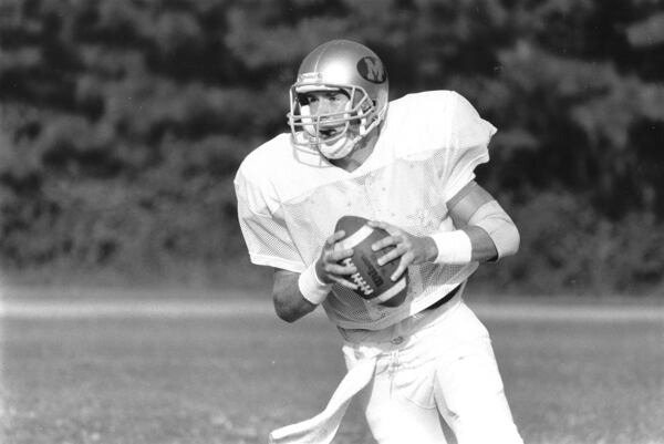 Brian Ellis searches for a receiver during a practice in February 1989. Ellis was a 1989 graduate of Morrow High in Clayton County, where he was a star quarterback. He then graduated from the U.S. Naval Academy in Annapolis, Maryland in 1993. (Kenneth Walker/AJC archive at GSU Library AJCP25-042b)