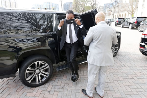 Atlanta mayor Andre Dickens puts on his mask as he arrives at United Methodist Church in Buckhead to the memorial service for the late U.S. Senator Johnny Isakson on Thursday, January 6, 2022. (Miguel Martinez for The Atlanta Journal-Constitution)