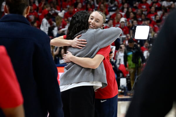 UConn guard Paige Bueckers hugs former player Sue Bird before pregame ceremony honoring Geno Auriemma and longtime assistant Chris Dailey, Wednesday, Nov. 20, 2024, in Storrs, Conn. (AP Photo/Jessica Hill)