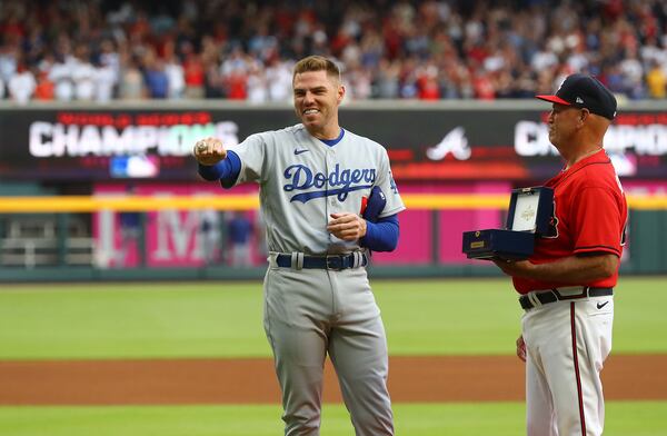 Braves manager Brian Snitker presents former Atlanta Braves first baseman Freddie Freeman his World Series Championship ring as he shows it off to the fans during his emotional return to Atlanta with the Los Angles Dodgers for a MLB baseball game on Friday, June 24, 2022, in Atlanta.    “Curtis Compton / Curtis.Compton@ajc.com”