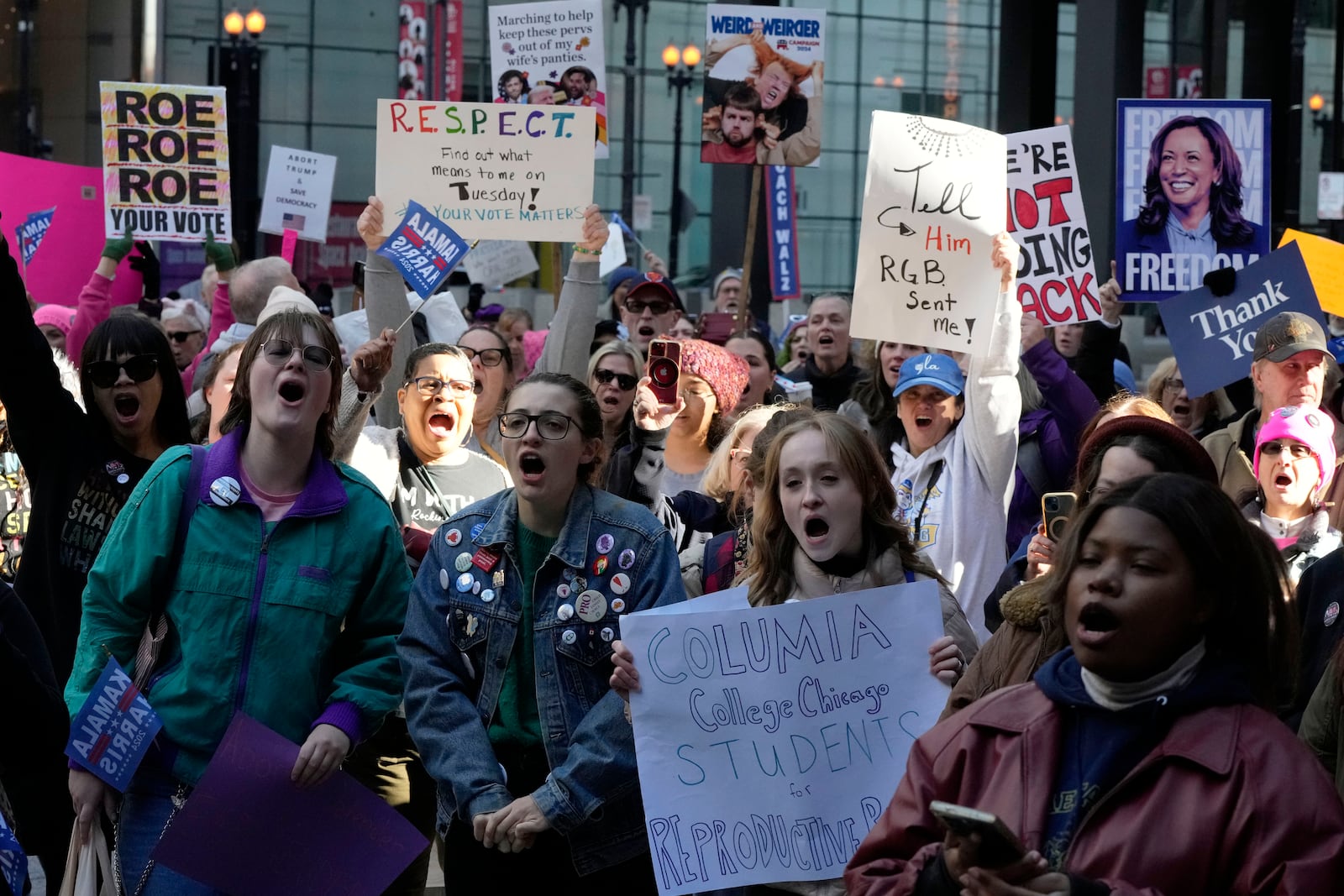 Women hold signs as they attend National Women's March in Chicago, Saturday, Nov. 2, 2024. (AP Photo/Nam Y. Huh)