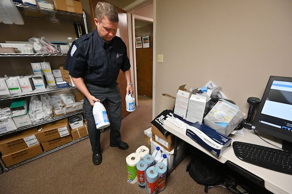 Paul Beamon, vice president of emergency medical services at AmeriPro EMS in Riverdale, unpacks supplies bought from local stores on Wednesday. As Georgia falls deeper into the grip of the coronavirus pandemic, medical professionals are having trouble finding enough supplies and equipment to treat patients and protect health care providers. With normal suppliers unable to keep up with demand, some medical professionals are using creative ways to find supplies, including purchasing masks from painting companies and Home Depot. (Hyosub Shin / Hyosub.Shin@ajc.com)