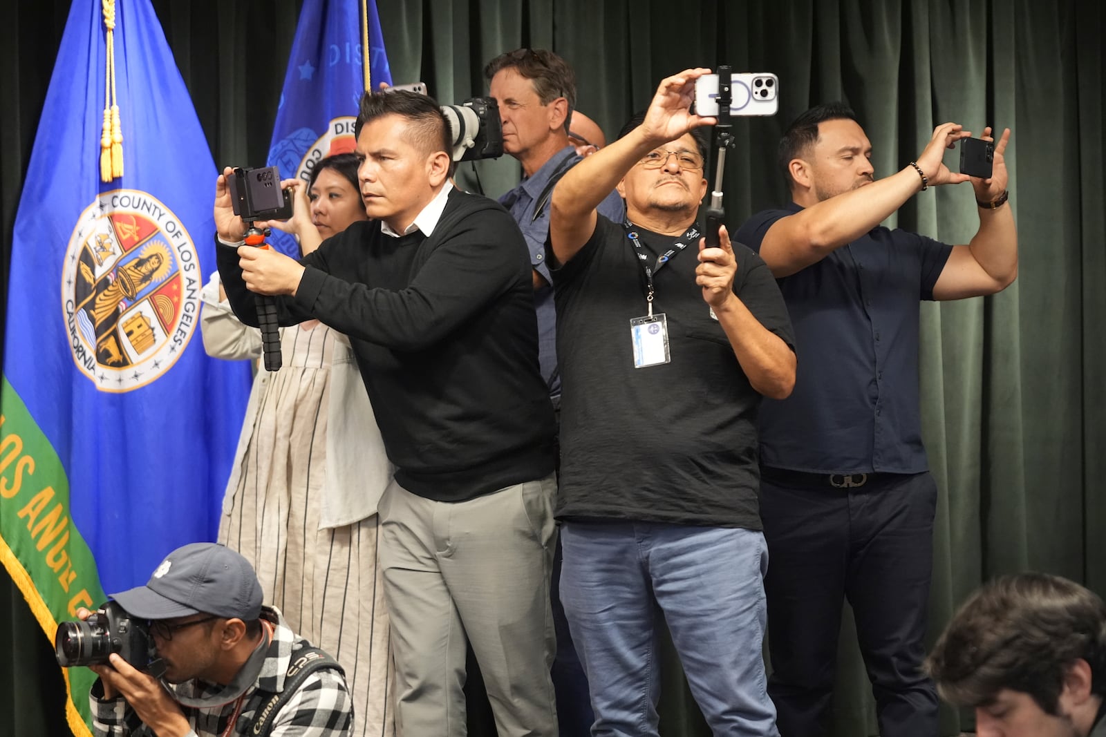 Members of the media take photos during a news conference about the Menedez brothers held by Los Angeles County District Attorney George Gascon, Thursday, Oct. 24, 2024, in Los Angeles. (AP Photo/Damian Dovarganes)