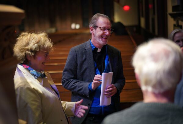 Cordelia Moyse, left, and her husband, the Rev. David Peck, talk with attendees after the weekly "Contemplative Citizenship" service at St. James Episcopal Church in Lancaster, Pa., on Tuesday, Oct. 15, 2024. (AP Photo/Jessie Wardarski)