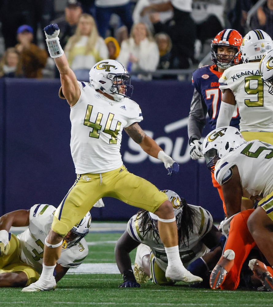 Georgia Tech Yellow Jackets linebacker Kyle Efford (44) and teammates celebrate after stopping Syracuse on fourth down during the second half of an NCAA college football game between Georgia Tech and Syracuse in Atlanta on Saturday, Nov. 18, 2023.  Georgia Tech won, 31 - 22. (Bob Andres for the Atlanta Journal Constitution)