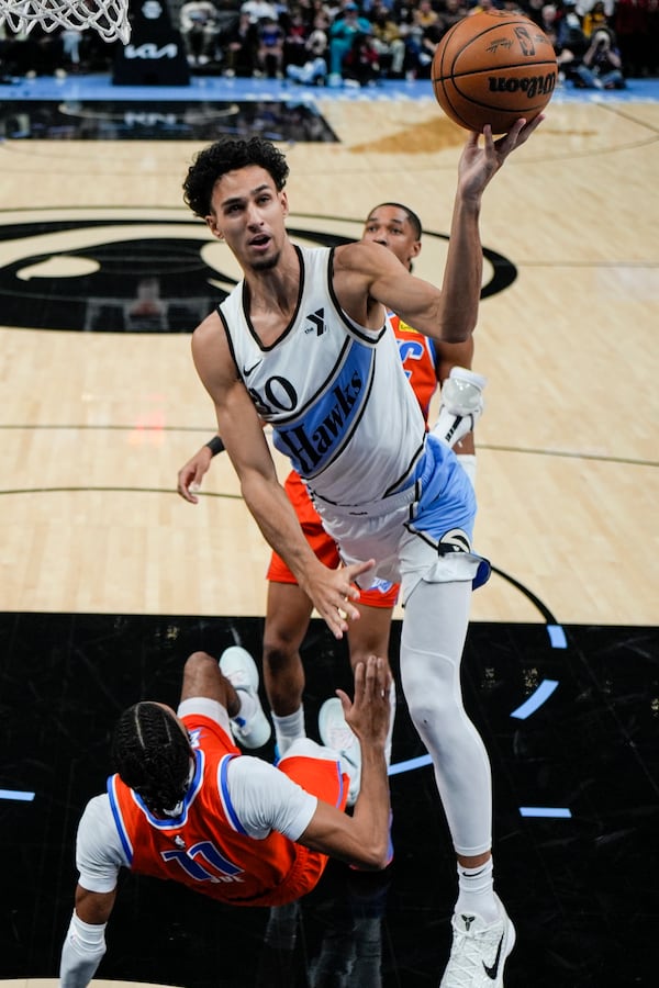 Atlanta Hawks forward Zaccharie Risacher (10) drives against Oklahoma City Thunder guard Isaiah Joe (11) during the first half of an NBA basketball game, Friday, Feb. 28, 2025, in Atlanta. (AP Photo/Mike Stewart)