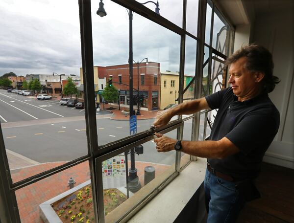 April 29, 2020 Marietta: Contractor Gordon Brans opens the original windows in the early 1900s hardware store while putting the finishing touches on Mac’s Chophouse restaurant on Wednesday, April 29, 2020, in Marietta. While renovations are almost done at the space that once housed Shillings on Marietta Square owner Randy McCray has said he won’t open the new restaurant until he feels comfortable things are better. Curtis Compton ccompton@ajc.com