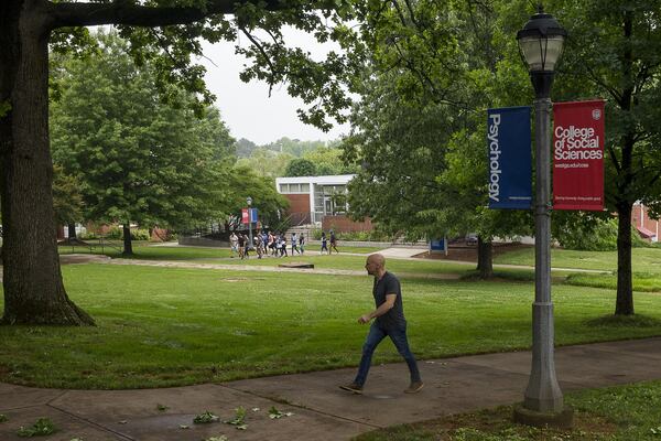 A man walks the campus at the University of West Georgia in Carrollton. The plot of land to the right of the man is where recent archaeological tests suggest slaves from a former plantation might be buried. If true, UWG will be added to a long list of colleges and communities challenged with questions on how to deal with newly discovered remains of former slaves and Reconstruction-era African Americans. (ALYSSA POINTER/ALYSSA.POINTER@AJC.COM)