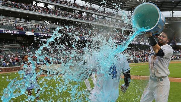  Braves teammates shower Brandon Phillips after his game-ending single Sunday, his second walk-off hits to beat the Marlins in as many days. (Curtis Compton/AJC photo)