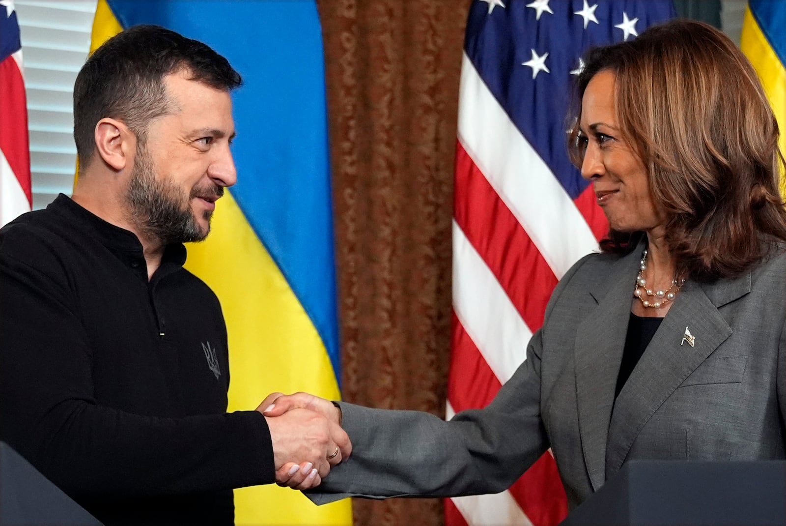 FILE - Vice President Kamala Harris, right, and Ukraine's President Volodymyr Zelenskyy, shake hands during their meeting on Sept. 26, 2024, in the vice president's ceremonial office inside the Eisenhower Executive Office Building on the White House complex in Washington. (AP Photo/Jacquelyn Martin, File)