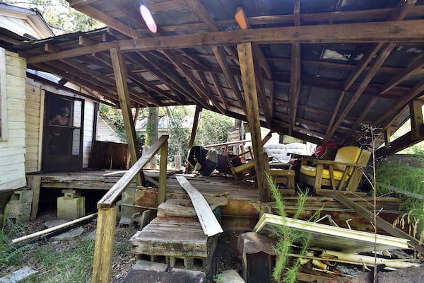 Larry Burkes in Cuthbert, Ga., looks out at his pack porch, which was severely damaged by Hurricane Michael in 2018. Burkes still lives in one of many damaged houses from Hurricane Michael, but still was not fixed nearly a year later. (Hyosub Shin / Hyosub.Shin@ajc.com)