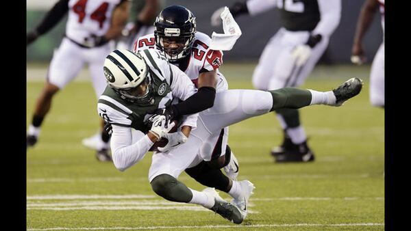 Atlanta Falcons cornerback Damontae Kazee (27) tackles New York Jets' Jermaine Kearse (10) during the first half of a preseason NFL football game Friday, Aug. 10, 2018, in East Rutherford, N.J. (AP Photo/Bill Kostroun) 