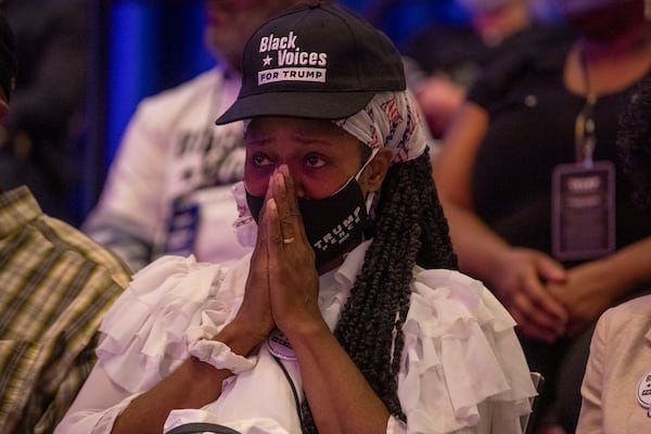 A supporter of President Trump becomes emotional Friday while listening to speakers during a Blacks for Trump campaign rally at the Cobb Galleria Centre.  (Alyssa Pointer / Alyssa.Pointer@ajc.com)