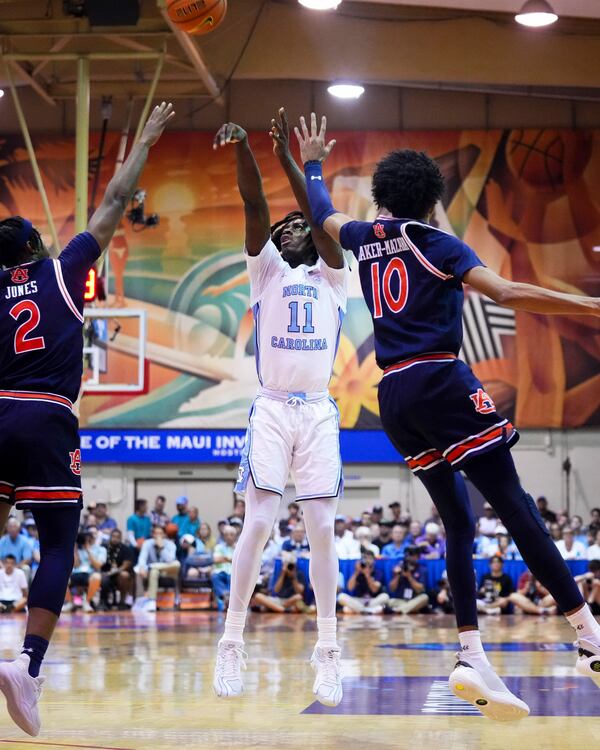 North Carolina guard Ian Jackson (11) shoots against Auburn guard Denver Jones (2) and guard Chad Baker-Mazara (10) during the first half of an NCAA college basketball game at the Maui Invitational Tuesday, Nov. 26, 2024, in Lahaina, Hawaii. (AP Photo/Lindsey Wasson)