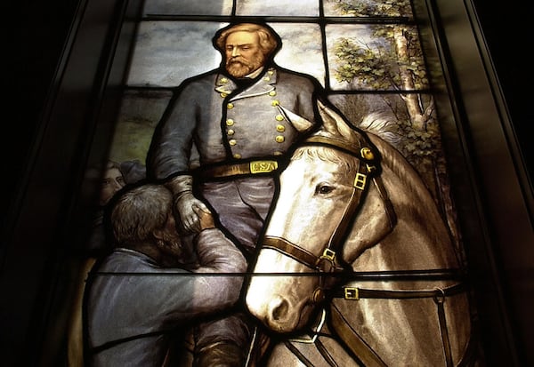 Inside historic Rhodes Hall, a series of stained glass windows tell the story of the “Lost Cause.” The building was once the home of the Georgia Archives.  (CHARLOTTE B. TEAGLE / AJC file)