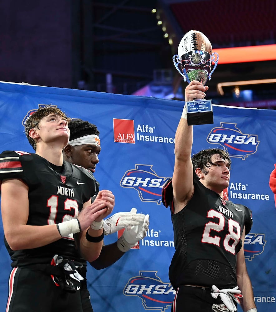 North Oconee’s Brody Taylor (28) along with team captains Landon Roldan (12) and Khamari Brooks (5) celebrate their win over Marist in their Class 4A championship game at the Mercedes-Benz Stadium Monday, Dec. 16, 2024. (Photo/Daniel Varnado)