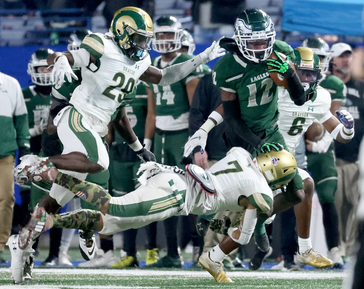 Dec. 30, 2020 - Atlanta, Ga: Collins Hill wide receiver Travis Hunter (12) is tackled by Grayson defenders Jibrahn Claude (7) and Tyler Pugh (29) after a reception by Hunter during the first half of their Class 7A state high school football final at Center Parc Stadium Wednesday, December 30, 2020 in Atlanta. JASON GETZ FOR THE ATLANTA JOURNAL-CONSTITUTION