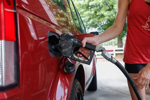 A woman pumps gas in Roswell, Ga, on Tuesday, May 21, 2024. (Natrice Miller/ AJC)