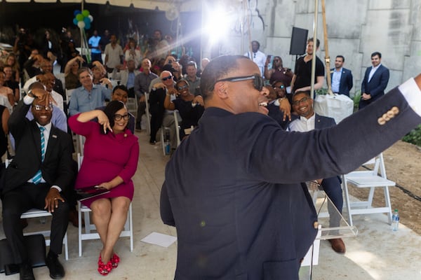 Atlanta Beltline, Inc. CEO Clyde Higgs takes a group selfie with people in the crowd as they throw up the “A” symbol on Mayson St. on Monday, July 24, 2023 in Atlanta. The event spoke on highlighting the Atlanta’s Beltline receiving $25M construction grant. (Michael Blackshire/Michael.blackshire@ajc.com)