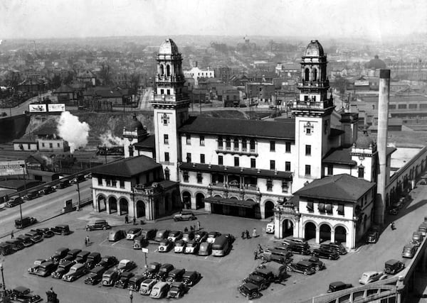 A 1930s view of Atlanta's Terminal Station. Architecture critics complained that Terminal Station's original symmetry and 'cathedral image' were ruined when, just before World War II, the two ornated and columned 100-foot towers were whacked down to 65 feet. Terminal Station, built in 1905, was demolished to make way for the Richard B. Russell building. In the lower right corner sits a statue of Samuel Spencer, the first president of Southern Railway, who died in 1906. The statue is now at the Norfolk Southern corporation building on Peachtree Street.