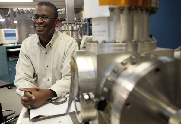 Atlanta inventor Lonnie Johnson, the creator of the Super Soaker, stands next to a sputtering system machine in his lab in downtown Atlanta. AJC FILE PHOTO.