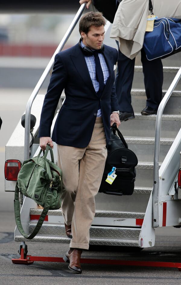 New England Patriots quarterback Tom Brady arrives at Sky Harbor Airport for NFL Super Bowl XLIX football game against the Seattle Seahawks Monday, Jan. 26, 2015, in Phoenix. (AP Photo/David J. Phillip) New England Patriots quarterback Tom Brady arrives at Sky Harbor Airport for NFL Super Bowl XLIX football game against the Seattle Seahawks Monday, Jan. 26, 2015, in Phoenix. (AP Photo/David J. Phillip)