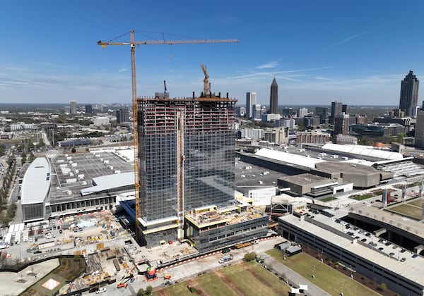 (**EMBARGO:  Do not use this photo until Tuesday morning, March 28, 2023** Hyosub) Aerial photograph shows construction site of Signia by Hilton Atlanta at Georgia World Congress Center, as construction crew prepare for topping out ceremony, Thursday, March 23, 2023, in Atlanta. Plans are in motion for GWCCA’s new headquarter hotel Signia by Hilton Atlanta. Featuring close to 1,000 rooms, this premier full-service hotel will sit on the northwest corner of the campus, adjacent to Building C of Georgia World Congress Center. (Hyosub Shin / Hyosub.Shin@ajc.com)