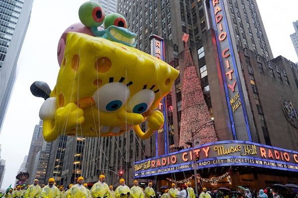 Handlers guide the SpongeBob SquarePants balloon down Sixth Avenue during the Macy's Thanksgiving Day Parade, Thursday, Nov. 28, 2024, in New York. (AP Photo/Julia Demaree Nikhinson)