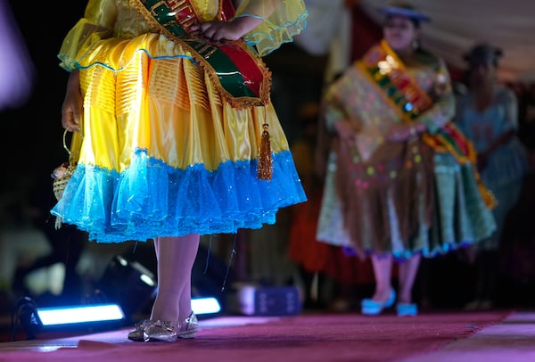 Women model creations by a local designer at a Chola fashion show, promoting the Andean style and beauty of Aymara women, in Viacha, Bolivia, Friday, Nov. 29, 2024. (AP Photo/Juan Karita)