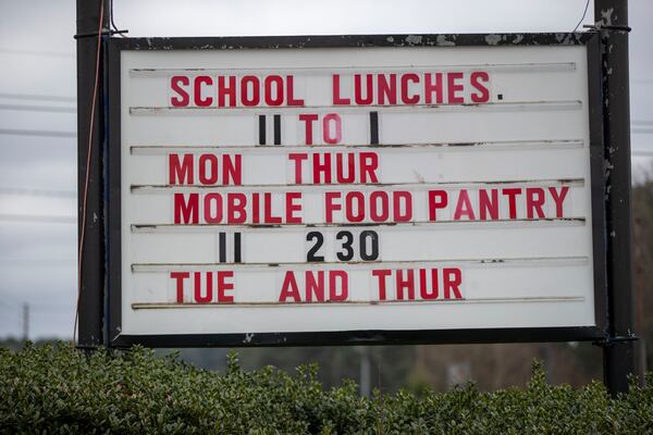 The Hearts to Nourish Hope mobile pantry in Riverdale displays its operating hours. The post-COVID recovery is already starting to look like one where the generally well-off quickly bounce back and poorer people don’t. (Alyssa Pointer / Alyssa.Pointer@ajc.com)