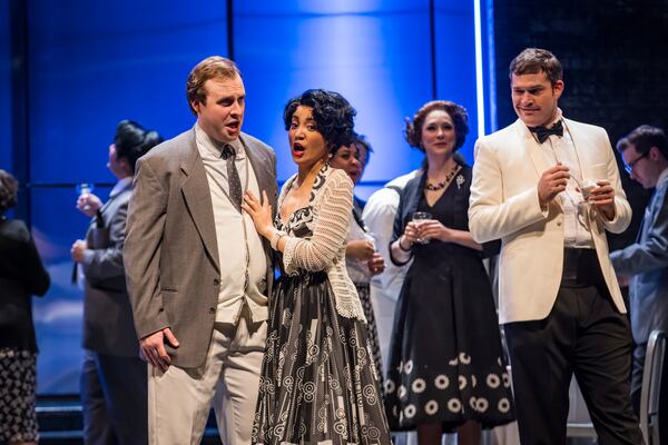 Jack Swanson as Don Giovanni, right, in white jacket, has his eye on Zerlina, (Meigui Zhang) center, while her fiancé Masetto (Andrew Gilstrap) stands by.