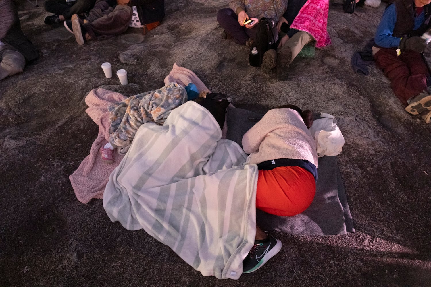 People sleep before the start of Easter sunrise service on top of Stone Mountain on Sunday, March 31, 2024.   (Ben Gray / Ben@BenGray.com)