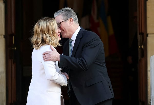 Britain's Prime Minister Keir Starmer, right, welcomes Italian Prime Minister Giorgia Meloni to the European leaders' summit to discuss Ukraine, at Lancaster House, London, Sunday March 2, 2025. (Toby Melville/Pool via AP)