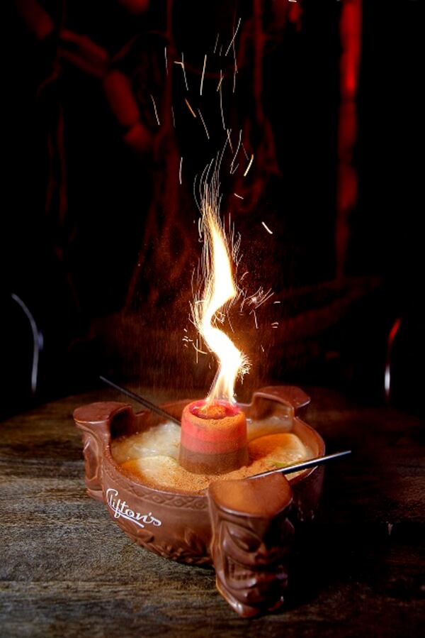 The Scorpion Bowl at the Pacific Seas tiki bar on the top floor of Clifton's in Los Angeles. Use lemon extract for an orange flame or a little Bacardi 151 if you want your flame to burn blue. (Kirk McKoy/Los Angeles Times/TNS)