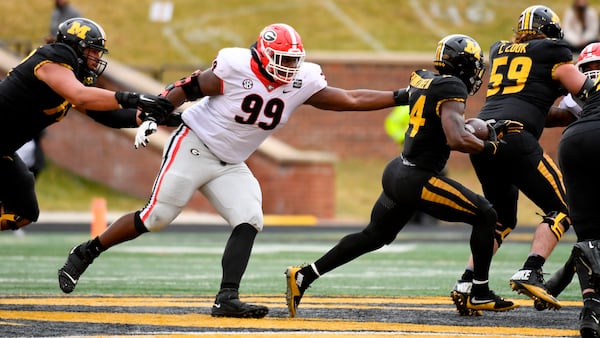 Georgia defensive lineman Jordan Davis (99) defends as Missouri running back Larry Rountree III (right) runs with the ball Saturday, Dec. 12, 2020, in Columbia, Mo. (L.G. Patterson/AP)