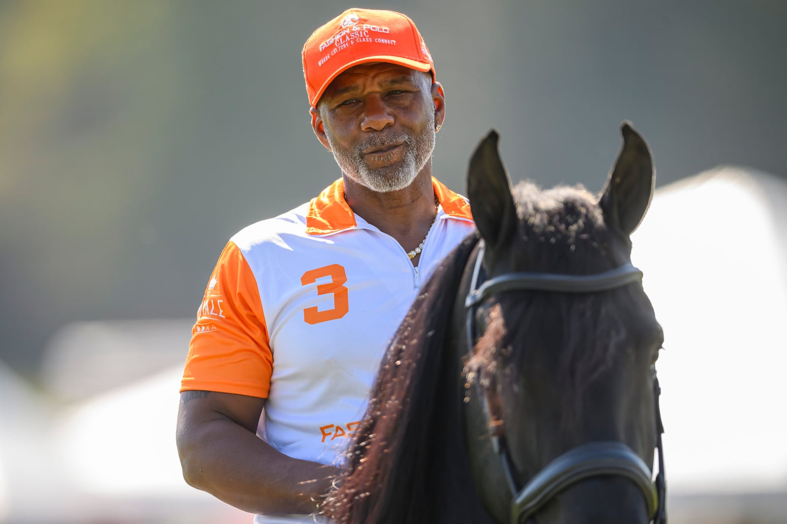 Fashion designer Miguel Wilson, the founder of the B.E.S.T. Academy Polo team, visits with guests during his grand showcase of fashion and equestrianism where the team debuted on Oct. 13, 2024, in Fairburn, GA. (Jim Blackburn for the AJC)