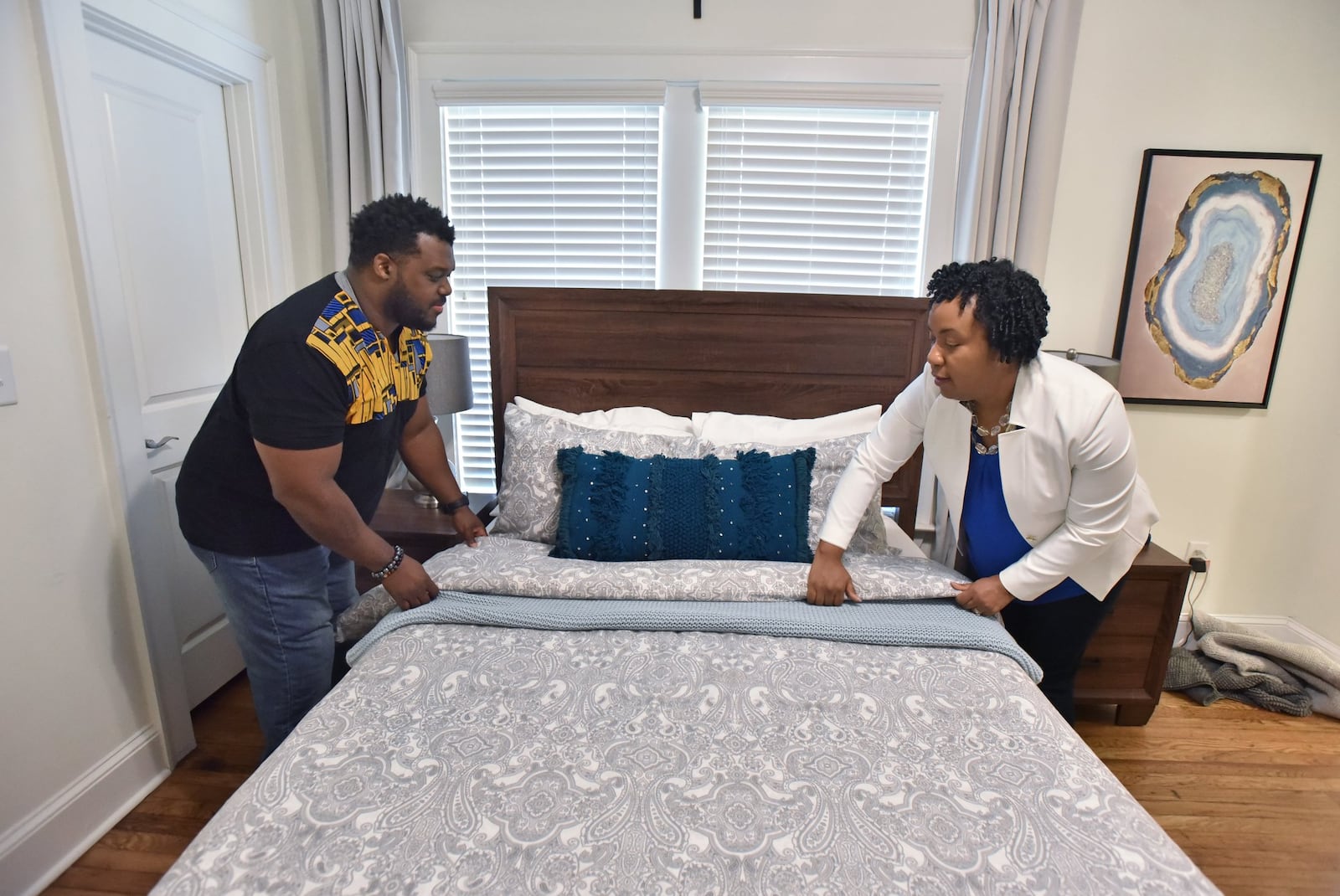 Justin and Charalaina Heard make a bed for their Airbnb guests at their lease home in Edgewood neighborhood on Thursday, April 11, 2019. Last May, when Justin and Charalaina Heard finally decided to lease their Edgewood bungalow as an Airbnb and Homeaway site. HYOSUB SHIN / HSHIN@AJC.COM