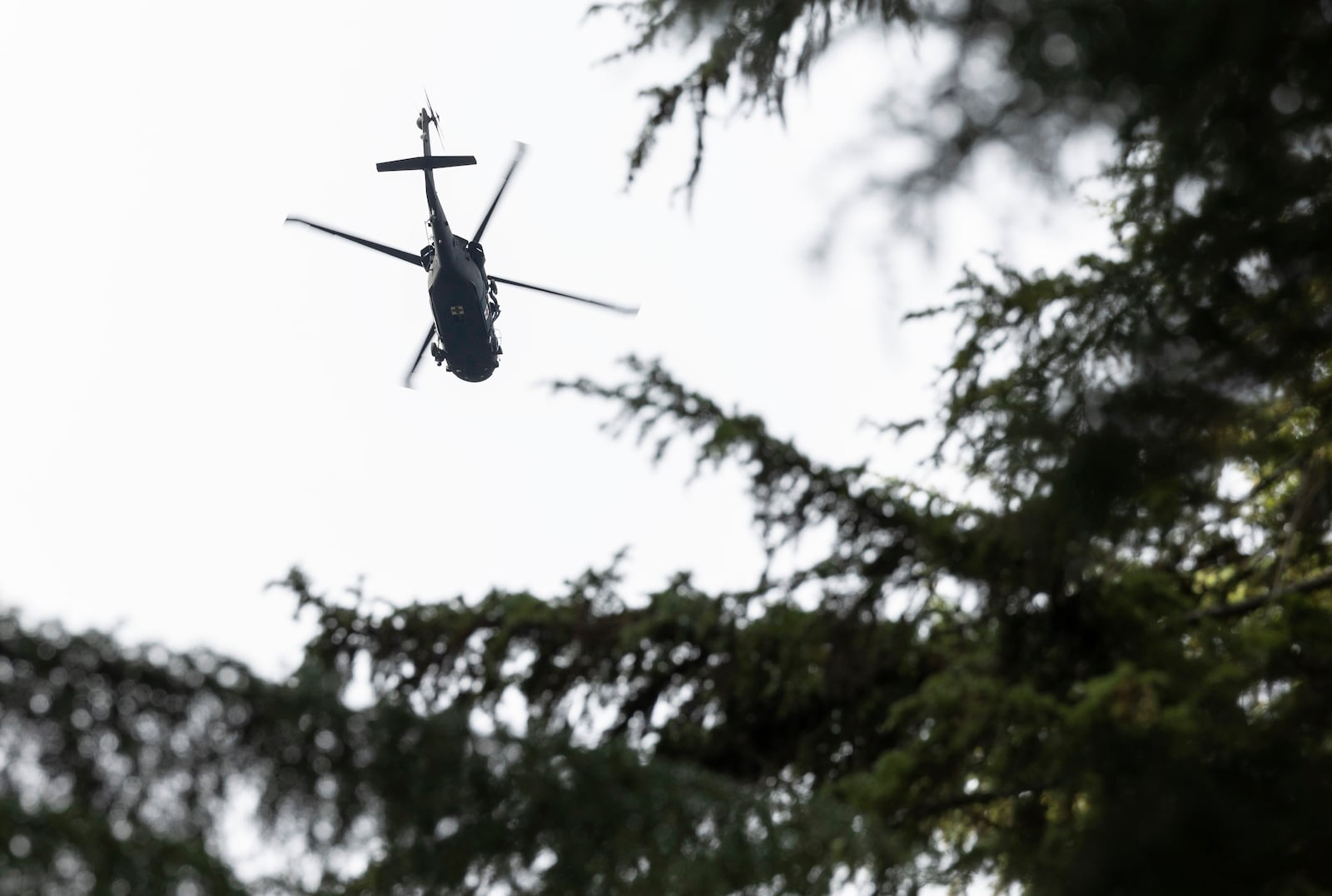 A U.S. Army helicopter continues searching for two missing aviators on Thursday, Oct. 17, 2024, near Goose Prairie, Yakima County, Wash., as the search continues for two fighter pilots whose EA-18G Growler jet crashed east of Mount Rainier. (Nick Wagner/The Seattle Times via AP)