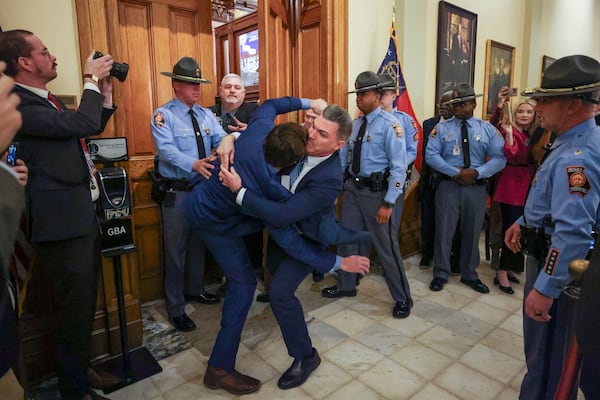 Georgia state Sen. Colton Moore, R-Trenton, scuffles with a staff member as he attempts to enter the state House of Representatives for the state of the state address at the Georgia Capitol, Thursday, Jan. 16, 2025, in Atlanta. Moore was detained by Georgia State Patrol and staff for attempting to enter the state House of Representatives. He was banned from the House last year after comments he made about the late House Speaker David Ralston. (Jason Getz/AJC)