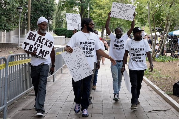 FILE - Supporters of former President Donald Trump with signs and t-shirts that read "Blacks for Trump" gather near the E. Barrett Prettyman U.S. Federal Courthouse, Aug. 3, 2023, in Washington. (AP Photo/Mariam Zuhaib, File)