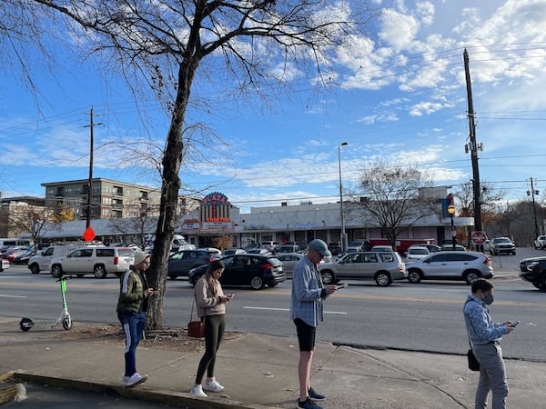 At 3:30 p.m .the line at the library on Ponce de Leon stretched almost back to North Highland Avenue. (Last person is directly across the street from the Plaza Theatre marquee. (Pete Corson / AJC)