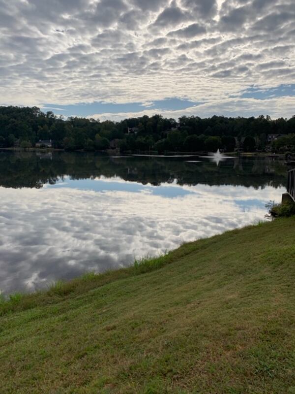 "This is a picture my husband Earl took of the lake in our community with the clouds reflecting a bed looking like snow," wrote B.J. Gearhart