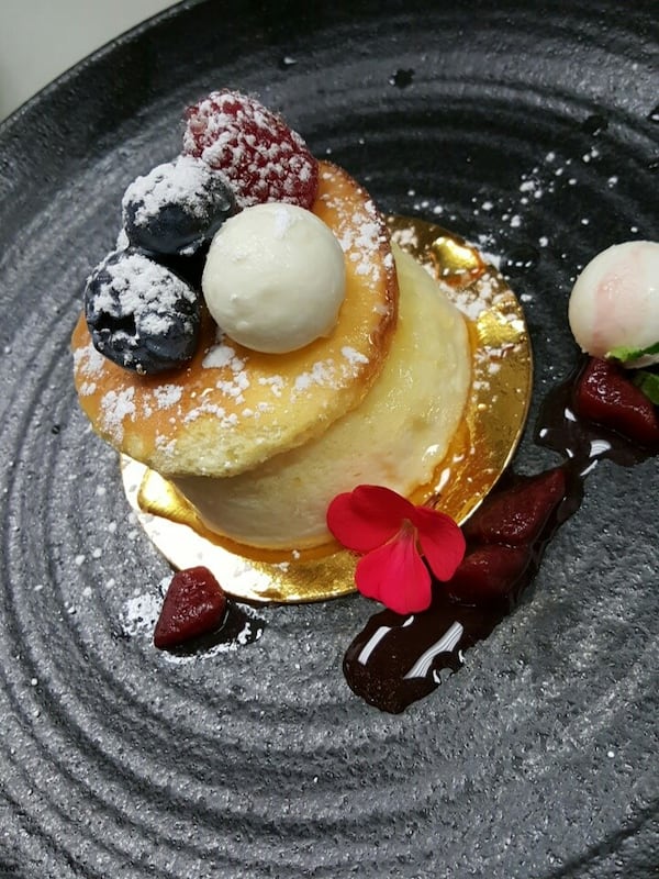 When Ito serves this cheesecake at Umi, she bakes the souffle in individual molds, then serves it with a disk of caramelized sugar, soft cheese ball, fresh berries and red wine currant sauce. / Provided by Lisa Ito