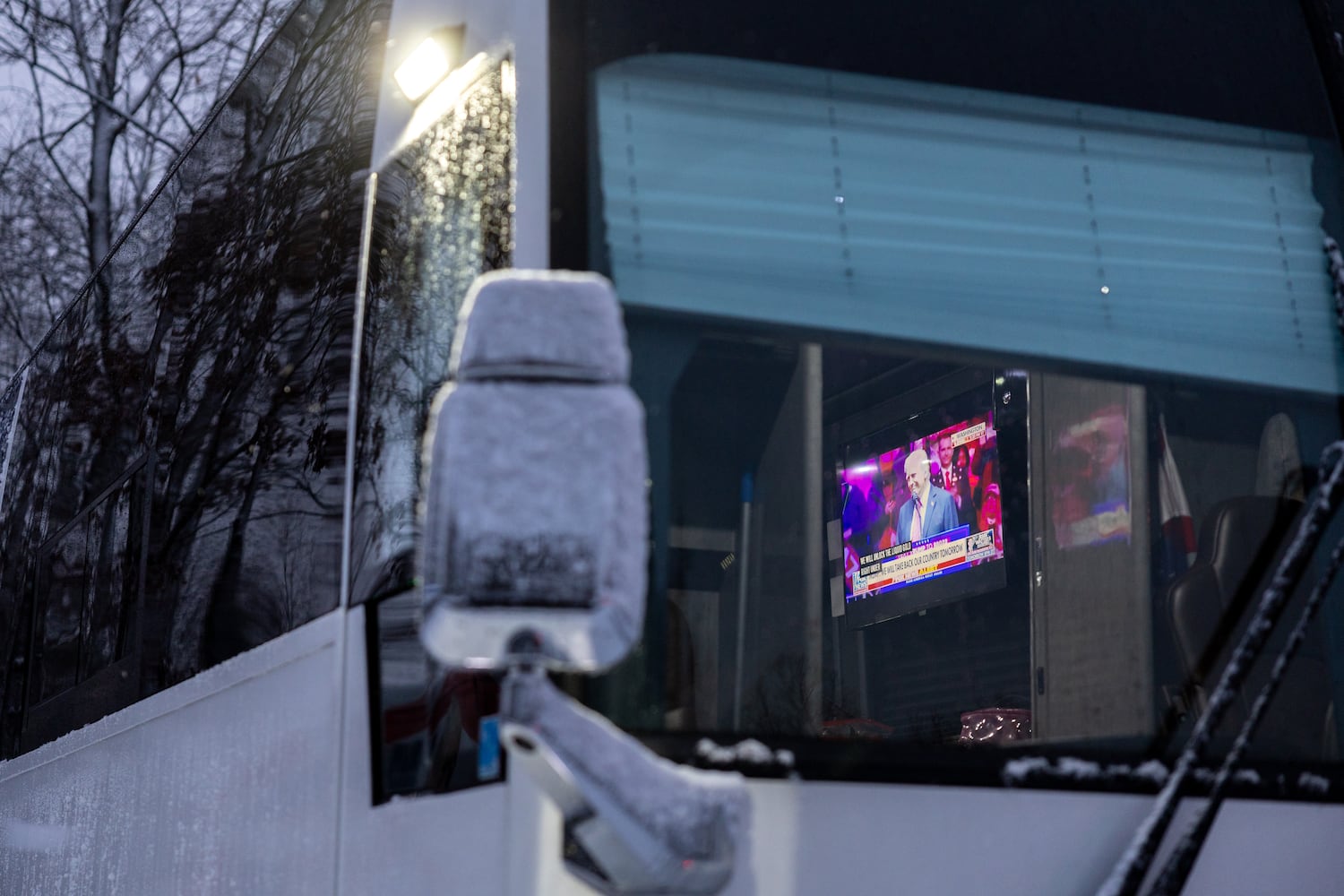 Members of a bus convoy from Georgia watch a Trump Rally live on Fox News at an RV park in College Park, Maryland on Sunday, January 19, 2025, one day before Donald Trump’s inauguration. (Arvin Temkar / AJC)