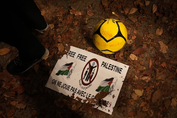 A soccer ball and a spotter are pictured during a rally in support of the Palestinian people, ahead of the Nations League soccer match France against Israel, Thursday, Nov. 14, 2024 in Saint-Denis, outside Paris. (AP Photo/Christophe Ena)