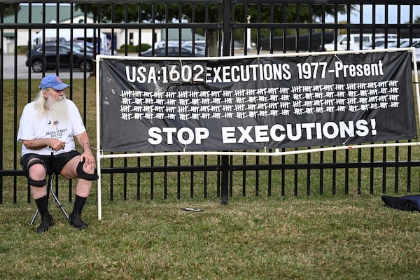 A protestor looks on prior to the scheduled execution of Richard Moore, Friday, Nov. 1, 2024, outside of Broad River Correctional Institution in Columbia , S.C. (AP Photo/Matt Kelley)